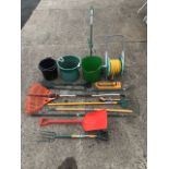 Miscellaneous garden tools - rakes, a fork & spade, bins, a snow shovel, a hosepipe on trolley, a