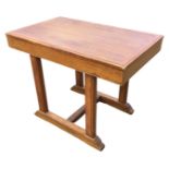 An oak centre table with panelled moulded top on rectangular supports above battens with fluted