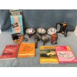 Miscellaneous motoring gear including headlamps, an old Lucas candlelamp, workshop manuals, a box of