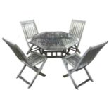 A teak garden table & chair set, the octagonal table with slatted top on a folding base with
