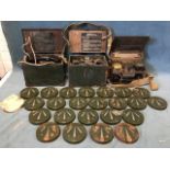 Three cased Second World War army field telephones, the boxes with brass mounts and canvas straps,