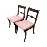 A pair of Victorian style mahogany chairs with bar backs above drop-in upholstered seats, raised