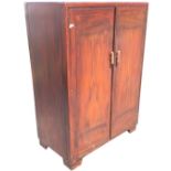 A stained compactum with rectangular moulded top above panelled doors enclosing an interior with