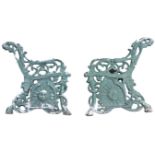 A pair of Victorian cast iron bench ends with pierced foliate scrolled arms and caryatid sabre