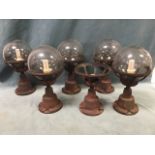 A set of six globe light fittings in metal cage type frames - one enclosure absent. (17.5in) (6)
