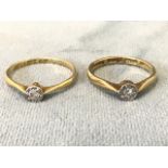 Two 18ct gold solitaire diamond rings with circular mounts. (2)