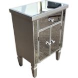 A contemporary mirrored cabinet with bevelled plates, the rectangular top above a drawer and