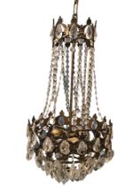 A bag chandelier, the foliate gilt metal rose suspending a scrolled brass frame hung with cut