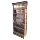 A C20th Globe-Wernicke oak stacking bookcase with six graduated up-and-over bevelled glass fronted