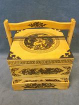 A Chinese painted wood picnic box, with two stacking compartments in a carrying tray, decorated with