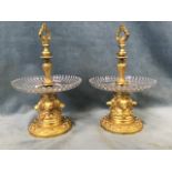 A pair of 19th century French ormolu and cut crystal comports, the loop handles on elaborately