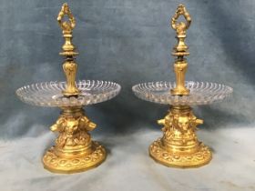 A pair of 19th century French ormolu and cut crystal comports, the loop handles on elaborately