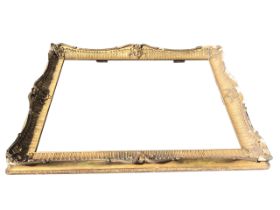 A large English mid-19th century giltwood swept picture frame, having rocaille fluted pattern with