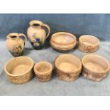 A collection of Hillstonia stoneware including two floral painted jugs, four cylindrical bark