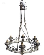 A wrought iron gothic style chandelier, the cylindrical upper section with scrolled and twisted