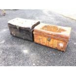 Two C20th tin trunks with rounded studded hinged lids and brass locks, having carriage handles to