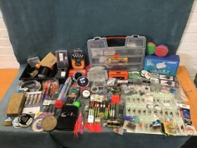 A quantity of fishing tackle including weights, spinners, floats, hooks, lines, boxes, backing,