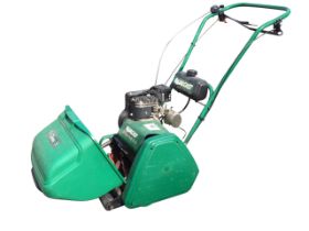 A Qualcast Classic garden petrol lawnmower, with grassbox.