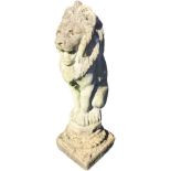 A composition stone garden figure of a seated lion, on a square plinth. (29in)