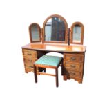 A mahogany dressing table and stool, the hinged triple arched mirrors above a moulded top