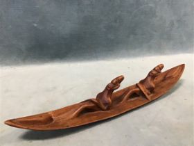 An West African carved hardwood canoe with two rowers. (12in)