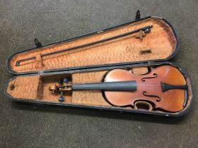 A cased C20th violin with single-piece back, and mother-of-pearl inlaid bow with spare strings, in