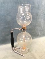 A 1930s Pyrex Cona coffee maker, with chrome and wood stand and spirit burner. (16.5in)