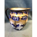 A 20th century Losol jug with arts and crafts style blue floral and gilt decoration. (9.5in)
