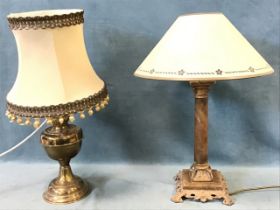 An art nouveau style column tablelamp with pierced scrolled decoration fitted with conical shade;