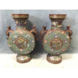 A pair of Chinese cloisonné moon flasks, with flared necks above flat circular bodies decorated with