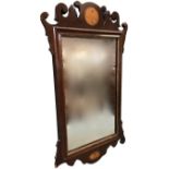 A Georgian style walnut mirror inlaid with shell medallions, having rectangular plate with gilt slip