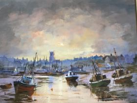 Oil on board, sunset estuary scene with beached boats and village background, signed with initials