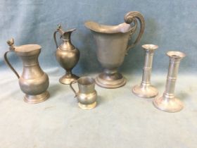 A collection of French pewter - a Louis XIV style wide mouth ewer, two covered jugs, a cream jug and