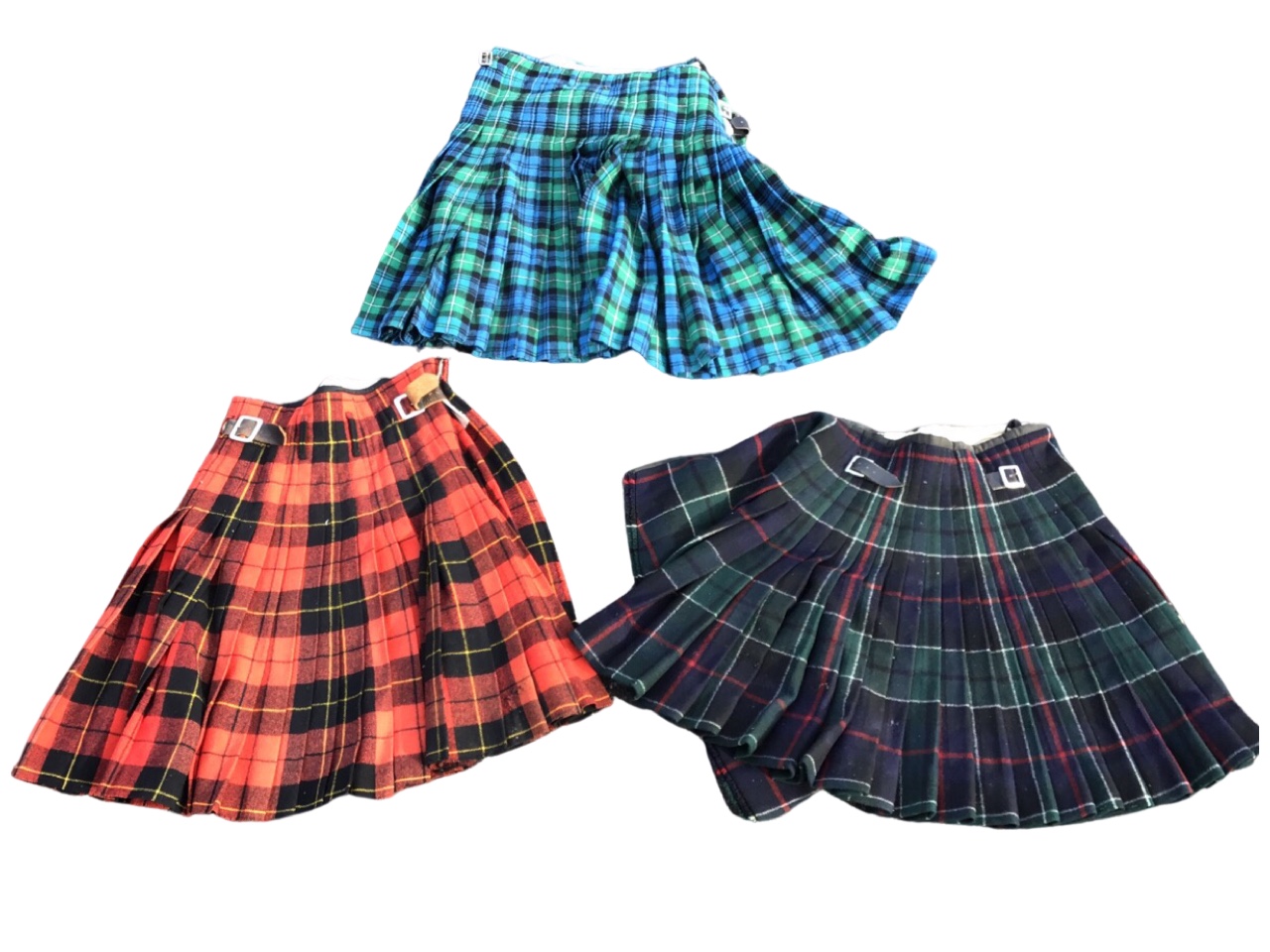 Three C20th Scottish wool tartan kilts, with leather straps. (3)