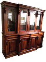 A reproduction Victorian mahogany breakfront bookcase with moulded cornice above four glazed doors