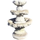 A composition stone three tier garden fountain or planter, the scalloped bowls on leaf moulded