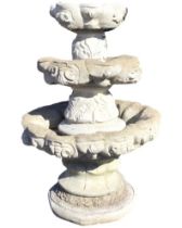 A composition stone three tier garden fountain or planter, the scalloped bowls on leaf moulded