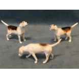 A trio of Beswick hunting hounds modelled in various poses, stamped on undersides. (3)