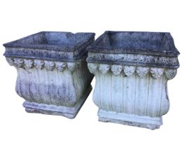 A pair of square composition stone urn planters, with moulded leaf decoration and ribbed bulbous
