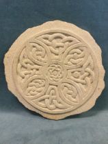 A circular hand carved sandstone celtic knot wall plaque, with quatrefoil interlace design. (13in)