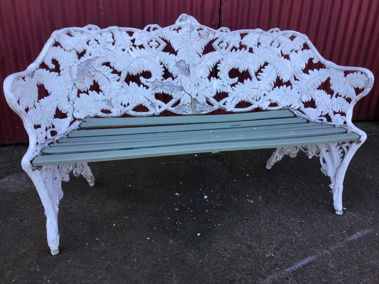 A Coalbrookdale style garden bench, in the fern and blackberry pattern, with wood slatted seat. (
