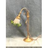 A brass arts and crafts style reading lamp, the mouth blown frilled ice glass shade on an adjustable