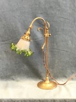 A brass arts and crafts style reading lamp, the mouth blown frilled ice glass shade on an adjustable