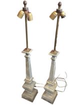 A pair of tall marble tablelamps, the square tapering columns mounted with tubular brass rods