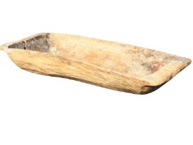 A large ancient sycamore trug adzed out of a solid log, the boat shaped bowl with angled ends. (