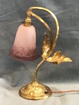 A brass arts and crafts style tablelamp, the signed Rethondes bell form glass shade on a curved loop