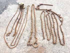 A chain pulley hoist; two long linked chains; and a tightening chain wrench. (4)