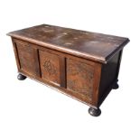 An Edwardian oak Jacobean style panelled coffer, with hinged rectangular moulded top, the front with