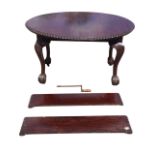 A late Victorian mahogany extending dining table with two leaves, the oval top with gadrooned edge