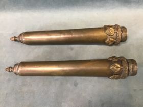 A pair of 19th century bronze finials with acorn caps above tapering cylindrical bodies and cast